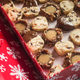 Holiday cookies in a red box with white snowflakes on it